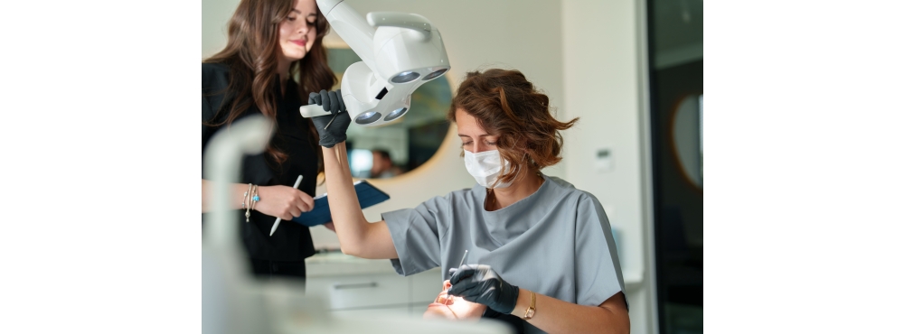 Dentist and dental assistant workingon a patient in an operatory. 